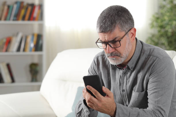 istock Confused adult man using a smart phone at home 1144612127