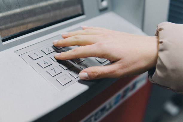 istock Withdrawing money from ATM 1144612158