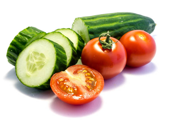 istock green cucumber and tomato isolated on white background 1144612438