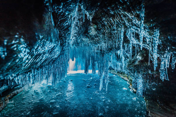 Ice stalactites hang from the ceiling of a limestone dissolution cave.