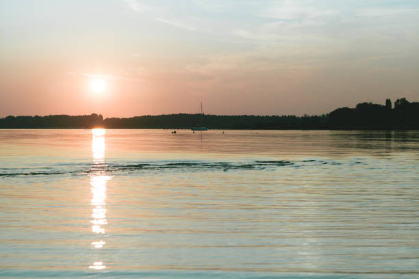 istock Amazing sunset in chiemsee lake with a sailboat navigating 1144612773