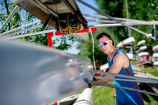 Young man preparing himself for rowing training