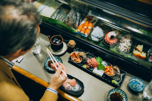 Japanese Male Eating Sushi stock photo
