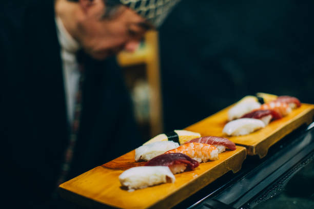 istock Japanese Chef Preparing Sushi 1144615072