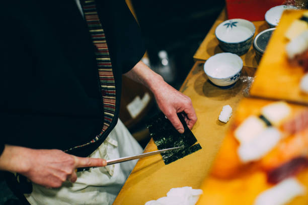 istock Japanese Chef Preparing Sushi 1144615074