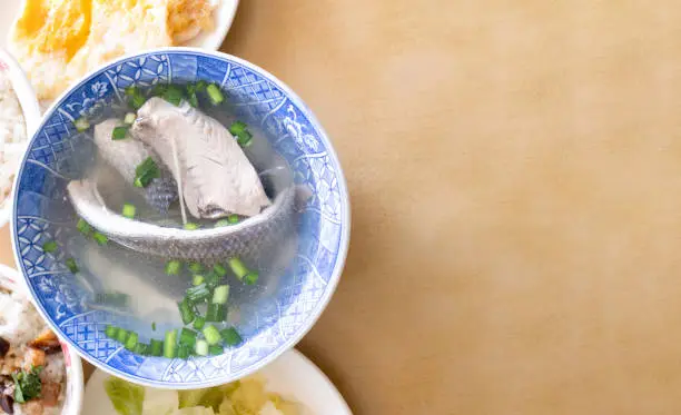 Photo of Milkfish skin soup, distinctive Taiwan delicacy food in Tainan. Famous meal set for lunch or breakfast with vegetable, top view, copy space, close up