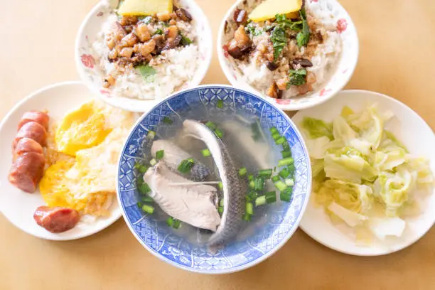 Photo of Milkfish skin soup, distinctive Taiwan delicacy food in Tainan. Famous meal set for lunch or breakfast with vegetable, top view, copy space, close up