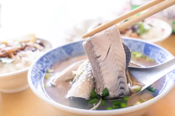 Photo of Milkfish skin soup, distinctive Taiwan delicacy food in Tainan. Famous meal set for lunch or breakfast with vegetable, top view, copy space, close up