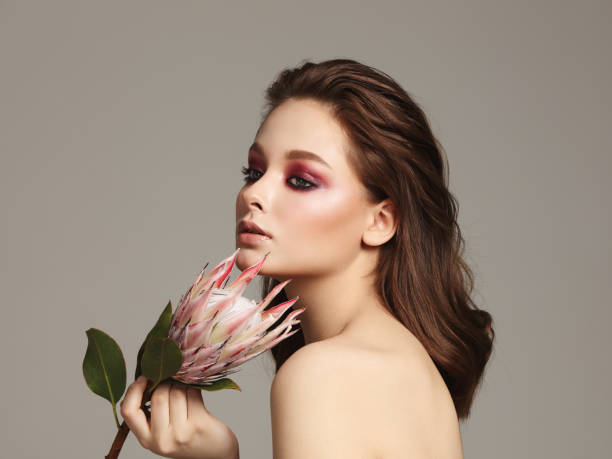 istock Beautiful girl with flower 1144616625