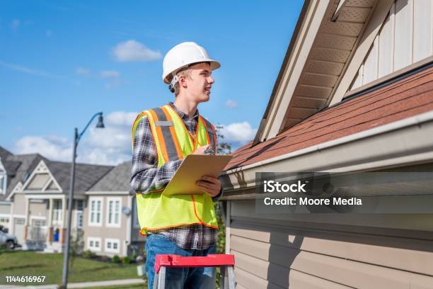 Home Inspector Providing An Inspection To A House Stock Photo - Download Image Now - Examining, Rooftop, Adult