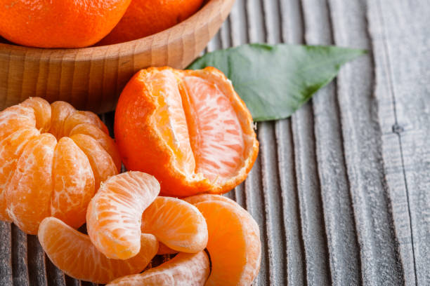 istock juicy mandarin on a gray wooden rustic background 1144617664