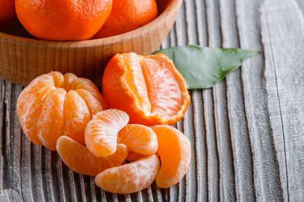 istock juicy mandarin on a gray wooden rustic background 1144617698