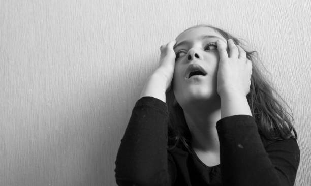 istock Little girl covers her face with her hands 1144617883