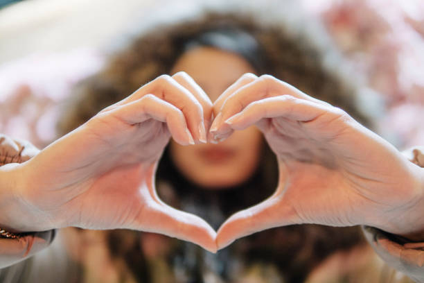 istock Young beautiful woman making heart with hands 1144618602