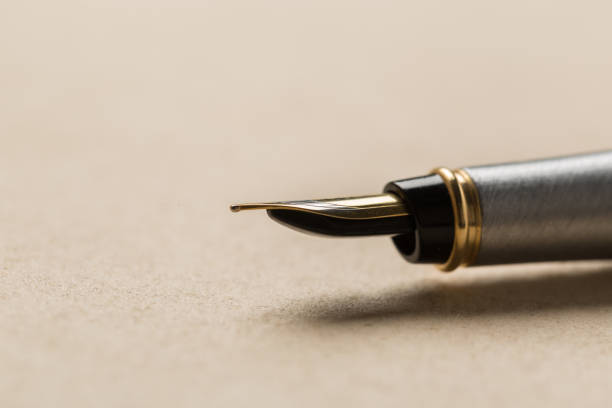 istock fountain pen on old paper. Vintage 1144619286