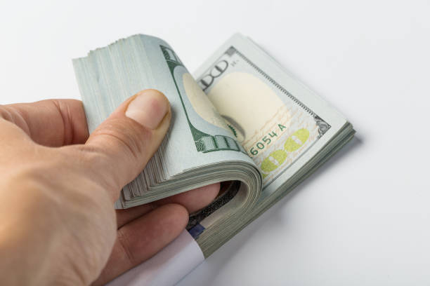 istock woman hand with dollars isolated on a white background 1144619291