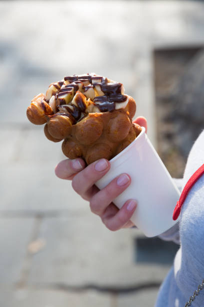 istock Hand with bubble waffle ice cream photo for graphic and web design, for website or mobile app. 1144619318