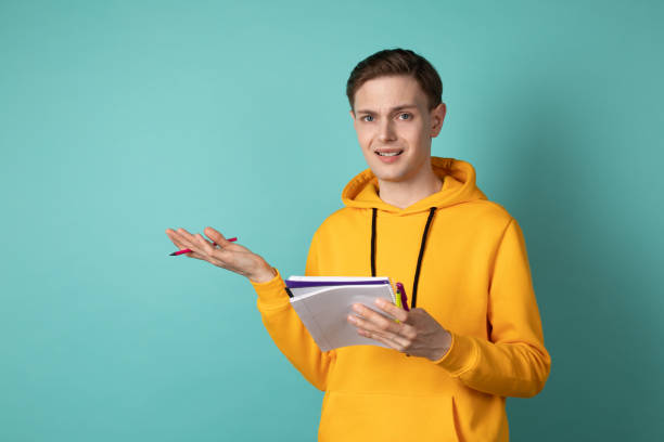 istock Young beautiful man manage, wearing casual clothes with notebook and pen in hands thinking about solving a difficult task 1144622710