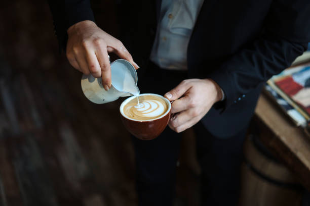 istock Barista holding coffee cup and make latte art coffee 1144622859