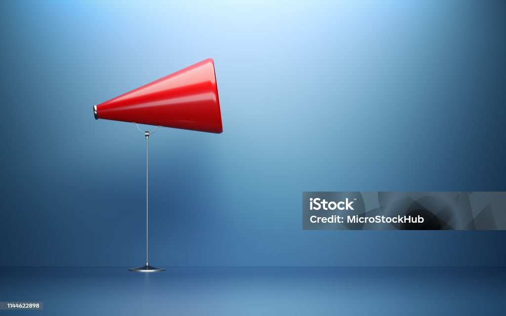 Red Megaphone  In Front Of Blue Wall Red megaphone  in front of blue wall. Horizontal composition with copy space. Great use for announcement concepts. Advertisement Stock Photo