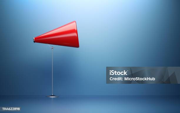 Red Megaphone In Front Of Blue Wall Stock Photo - Download Image Now - Advertisement, Megaphone, Individuality