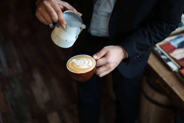 istock Barista holding coffee cup and make latte art coffee 1144623154