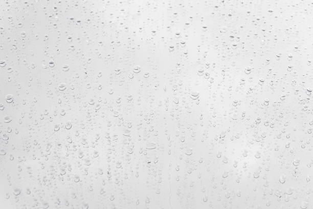 istock Water drops on glass white gray background. 1144623235
