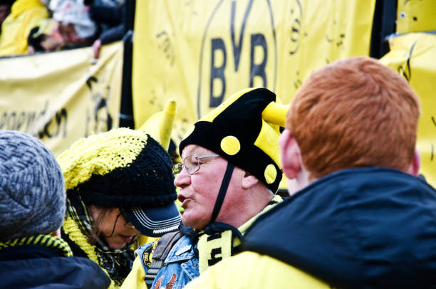 les touristes et les habitants (y compris un vieil homme) célèbrent avec le train de parade coloré du borussia dortmund à l’occasion du carnaval de dortmund (rose monday), sur la kampstrasse, en allemagne. - football police officer crowd photos et images de collection