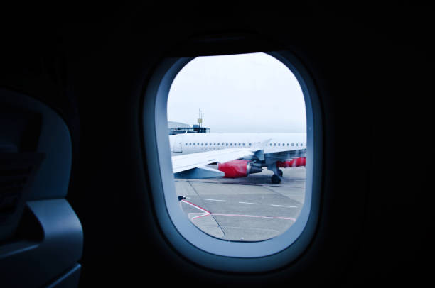 istock Window frame image of an airplane on the tarmac 1144624903