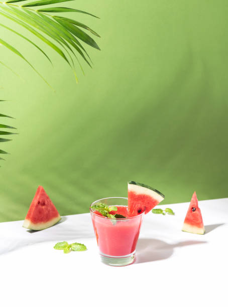 Fresh water melon juice and watermelon slice on color background. summer drink.