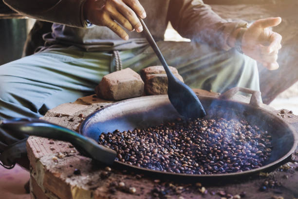 Asian men are sitting roasting coffee beans