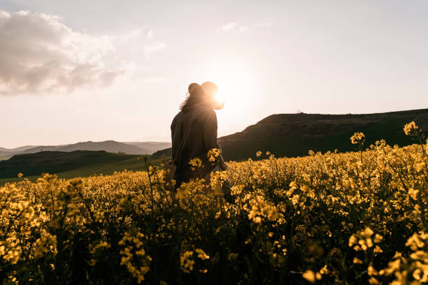 istock Unrecognizable woman walking among flowers 1144626276