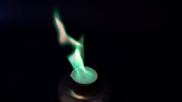 Burning copper and barium with a green flame. Chemical oxidation of copper and barium