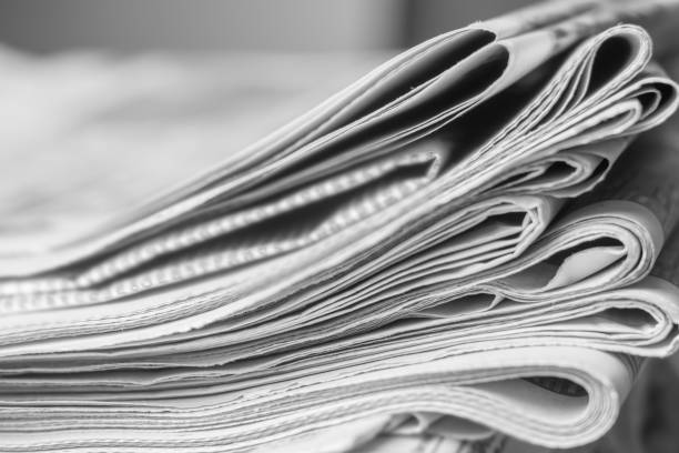 istock News concept, folded newspaper closeup. 1144628004