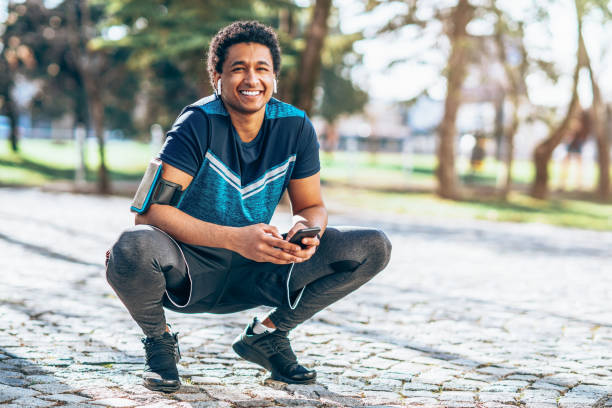 istock Smiling athlete with smart phone 1144630521
