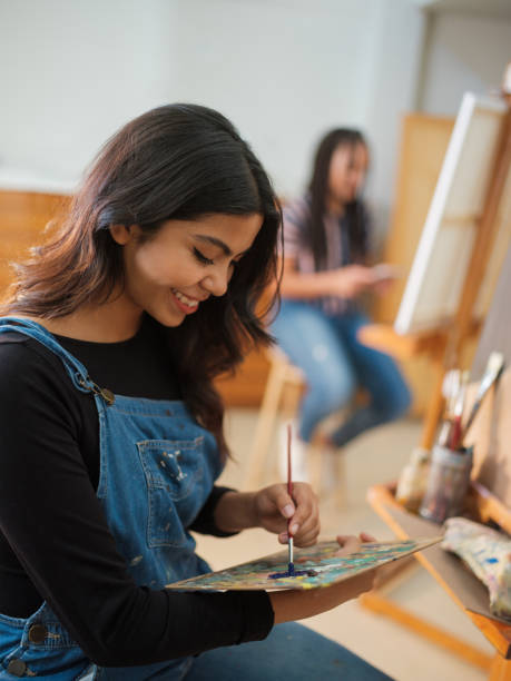 istock Beautiful latin art student using a paint palette 1144631609