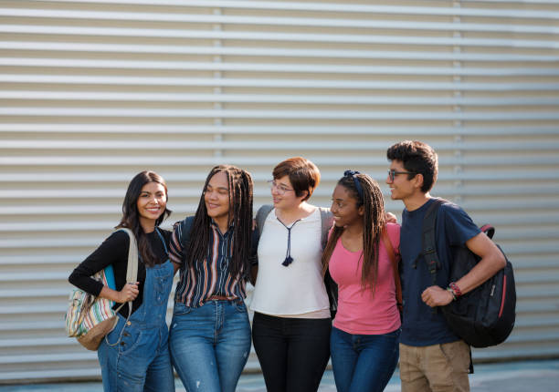 istock Beautiful latin student standing with her college friends 1144631661