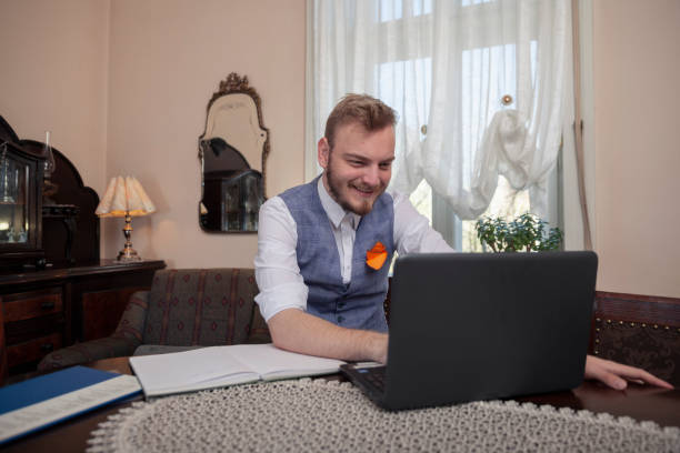 istock one young man, working on his laptop, at his apartment. 1144635354