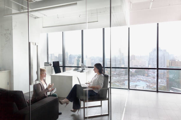 istock Women talking together in business office 1144636477