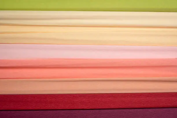 colorful rolls of  crepe paper - background with crinkled texture