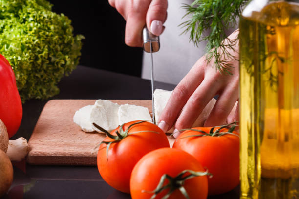 istock young woman slicing cheese in a gray apron 1144639318