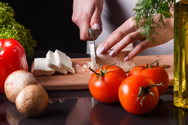 istock young woman slicing cheese in a gray apron 1144639499