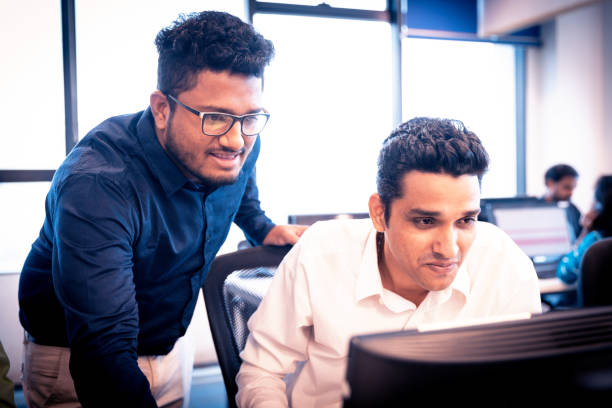 istock IT Engineer Providing Desktop Support to his Colleague 1144639709