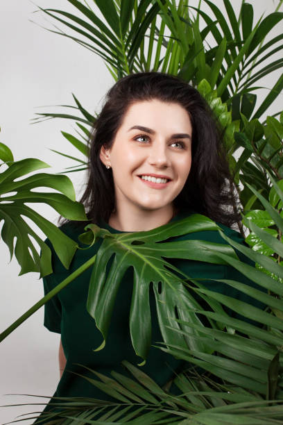 istock Young beautiful woman siting between large home plants. 1144641315