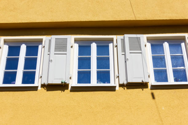istock orange historical house facades on blue sky 1144642456