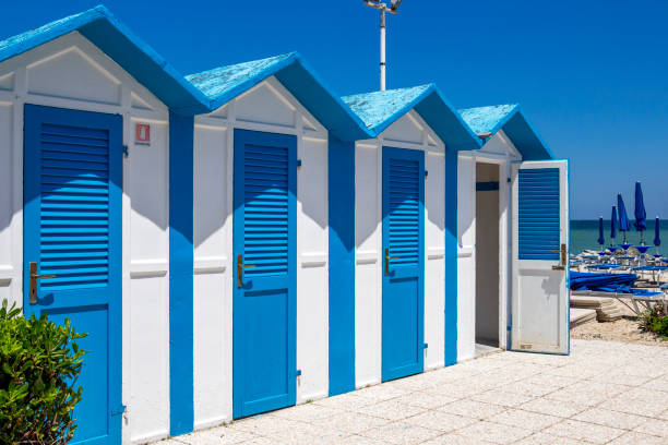 Beach huts at Porto Recanati, Italy Beautiful old blue and white painted beach huts at Porto Recanati, Province of Macerata, Marche, Italy macerata italy stock pictures, royalty-free photos & images