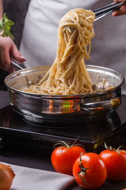 istock young woman in a gray apron preparing pasta 1144642838