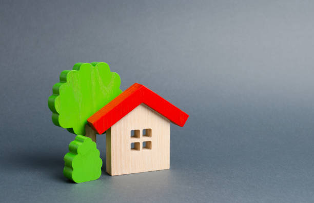 istock Wooden house and trees. Environmentally friendly and environmentally friendly home. Modern technology in construction. Quiet and cozy, comfortable affordable housing. Housing in the suburbs. 1144642966