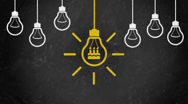 istock birthday cake Symbol with Bulb Concept Chalk Drawing on Blackboard 1144645802