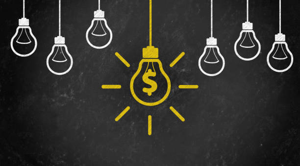 istock dollar and money Symbol with Bulb Concept Chalk Drawing on Blackboard 1144645828